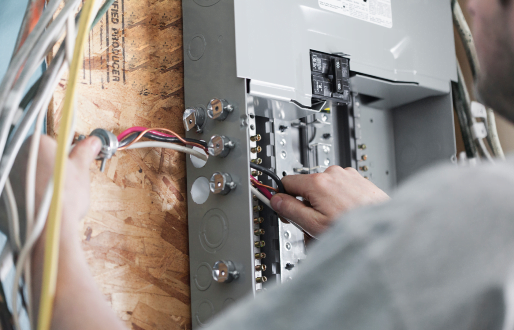 Electrician replacing the distribution board to upgrade a homes electrical panel.